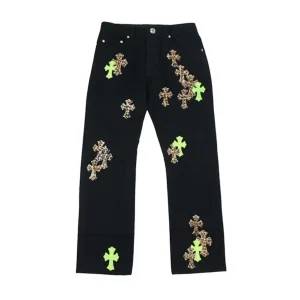 Rear view of Chrome Hearts black green cheetah cross patch denim jeans showing back pockets and leather cross patches